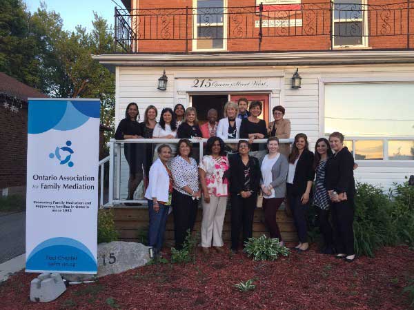 Peel Dufferin Family Mediation OAFM Chapter group photo in front of house with banner